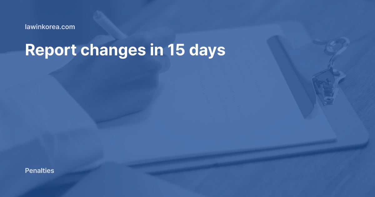 Hand writing on a clipboard on a wooden table: Got a New Passport? Report Changes to Alien Registration Details Within 15 Days or Face a Fine